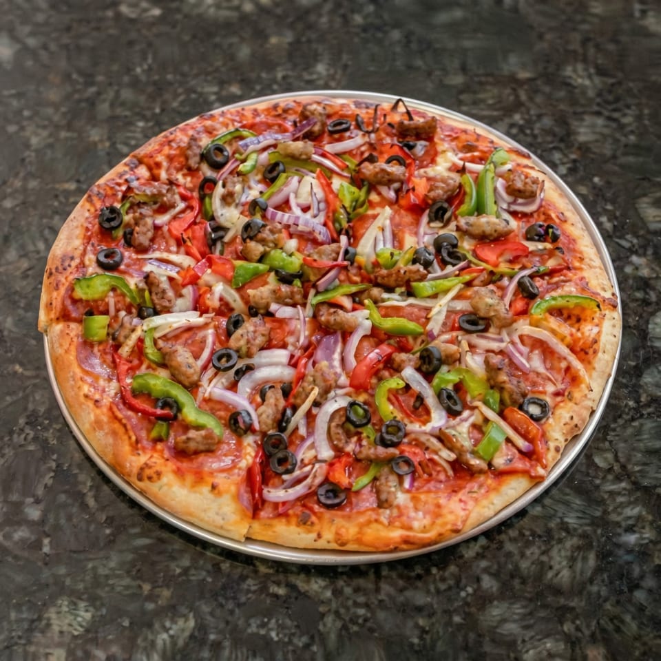 A whole pizza with pepperoni, sausage, black olives, red onions, and green and red peppers.
